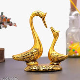 Golden brass pair of kissing swan figurine for home decor, shining love birds in a spiritual setting
